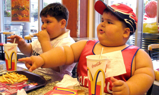 ** FILE ** Dzhambulat Khotokhov, right, a 4-year-old Russian weighing 56 kilograms (123 pounds) with a height of 118 centimeters (3 feet 11 inches), and Georgy Bibilauri, a Georgian, who turned 5 on Wednesday, 120 centimeters (4 feet) tall and weighs 51 kilograms (112 pounds), enjoy a meal at a McDonald's restaurant, in Tbilisi, Georgia in this Wednesday, July 9, 2003 file photo. Fast food giant McDonald's is to phase out it's supersize portions it announced Wednesday March 3, 2004, although it claimed that the supersize category represented a tiny portion of its business. (AP Photo/ Shakh Aivazov )