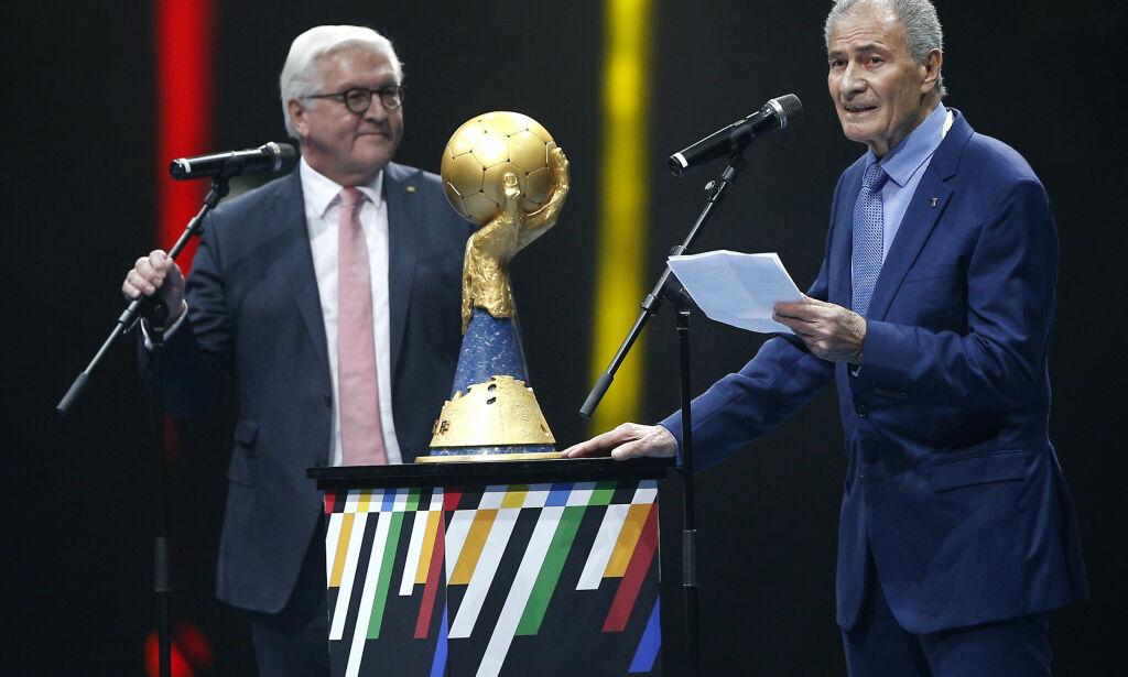 Hassan Moustafa, right, President of the International Handball Federation (IHF), delivers a speech during the championship opening ceremony prior to the Handball World Championship first round match between Korea and Germany in Berlin, Germany, Thursday, Jan. 10, 2019. At left is German President Frank-Walter Steinmeier.(AP Photo/Michael Sohn)